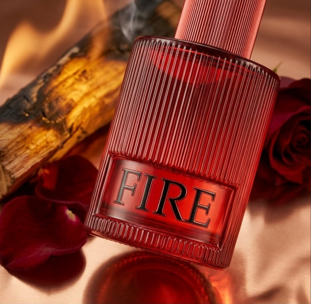 Red bottle labeled 'FIRE' with wooden elements and a rose on a warm-toned background