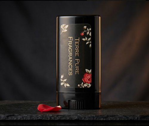 Black perfume bottle with floral design on a dark background