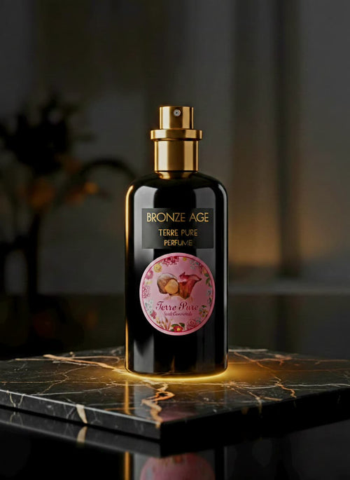 Perfume bottle labeled 'Bronze Age Terre Pure' on a dark surface with a blurred background